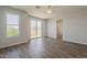 Bright bedroom with hardwood floors, a ceiling fan, and a sliding glass door leading to the balcony at 11752 N 135Th Pl, Scottsdale, AZ 85259