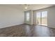 Bright bedroom with wood floors, ceiling fan, and a sliding door leading to a private balcony at 11752 N 135Th Pl, Scottsdale, AZ 85259
