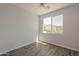 Bedroom featuring scenic views, wood floors, ceiling fan, and bright, natural light at 11752 N 135Th Pl, Scottsdale, AZ 85259