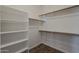 Walk-in closet with built-in shelving and wooden rods for maximum storage at 11752 N 135Th Pl, Scottsdale, AZ 85259
