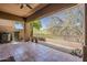 Relaxing covered patio with tile flooring, fan, and desert views at 11752 N 135Th Pl, Scottsdale, AZ 85259