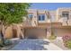South Scottsdale two-story townhome with a two-car garage, desert landscaping and block construction at 11752 N 135Th Pl, Scottsdale, AZ 85259