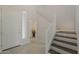 Foyer featuring tile floors, white walls, wooden staircase, and white front door at 11752 N 135Th Pl, Scottsdale, AZ 85259