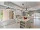 Bright white kitchen with stainless steel appliances, island and views at 11752 N 135Th Pl, Scottsdale, AZ 85259