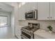Kitchen featuring white cabinetry, stainless steel KitchenAid appliances, and subway tile backsplash at 11752 N 135Th Pl, Scottsdale, AZ 85259