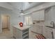 Modern kitchen with white cabinets, stainless steel appliances, a marble countertop island, and bright lighting at 11752 N 135Th Pl, Scottsdale, AZ 85259