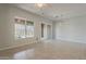 Bright living room with tile flooring, white walls and patio doors with nature views at 11752 N 135Th Pl, Scottsdale, AZ 85259