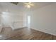 Loft area with wood floors, white walls, railing, and a view into an adjacent room at 11752 N 135Th Pl, Scottsdale, AZ 85259