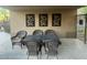 Patio area with outdoor seating and decorative wall art, offering an inviting space for relaxation and entertainment at 11752 N 135Th Pl, Scottsdale, AZ 85259