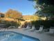 Inviting community pool with lounge chairs and desert landscaping at 11752 N 135Th Pl, Scottsdale, AZ 85259