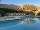 Relaxing community pool area with colorful flowers and desert landscaping at 11752 N 135Th Pl, Scottsdale, AZ 85259