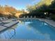 Community pool featuring lounge chairs, mature trees, and manicured landscaping at 11752 N 135Th Pl, Scottsdale, AZ 85259