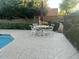 Relaxing poolside patio featuring an umbrella table, ideal for enjoying sunny days and outdoor dining at 11752 N 135Th Pl, Scottsdale, AZ 85259