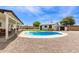 This backyard features an inground pool, an outdoor kitchen area, and a covered patio at 11842 N 30Th Dr, Phoenix, AZ 85029
