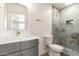 This updated bathroom features modern fixtures and a walk-in shower with light blue tiling at 11842 N 30Th Dr, Phoenix, AZ 85029