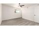Clean and simple bedroom featuring a ceiling fan, natural light, and light wood-look flooring at 11842 N 30Th Dr, Phoenix, AZ 85029