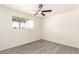 This bedroom features a ceiling fan and a window with a view of the neighborhood at 11842 N 30Th Dr, Phoenix, AZ 85029