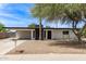 Charming single-story home featuring a xeriscaped yard, carport, and painted brick exterior at 11842 N 30Th Dr, Phoenix, AZ 85029