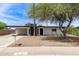 Charming single-story home featuring a xeriscaped yard, carport, and painted brick exterior at 11842 N 30Th Dr, Phoenix, AZ 85029