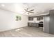 Spacious kitchen area featuring gray cabinets, stainless steel appliances, and modern lighting at 11842 N 30Th Dr, Phoenix, AZ 85029