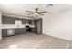 Open kitchen with gray cabinets, stainless steel appliances, and light-colored flooring at 11842 N 30Th Dr, Phoenix, AZ 85029