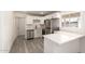 Well-lit kitchen with stainless steel appliances, white cabinets, and a breakfast bar area at 11842 N 30Th Dr, Phoenix, AZ 85029