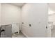 This laundry room has painted concrete block walls, light gray flooring and hookups for a washer and dryer at 11842 N 30Th Dr, Phoenix, AZ 85029