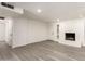 Bright living room with gray-toned flooring and neutral walls, fireplace, and recessed lighting at 11842 N 30Th Dr, Phoenix, AZ 85029