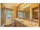Bright bathroom featuring dual sinks, tile countertops and views to the outdoors at 12646 N 80Th Pl, Scottsdale, AZ 85260