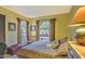 Cozy bedroom with natural light, a patterned bedspread, and closet space at 12646 N 80Th Pl, Scottsdale, AZ 85260