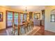 Elegant dining room with wood flooring, a decorative chandelier, and French doors to the outside at 12646 N 80Th Pl, Scottsdale, AZ 85260