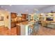Open kitchen and living area featuring granite countertops, custom cabinets, stainless appliances and tile flooring at 12646 N 80Th Pl, Scottsdale, AZ 85260
