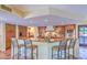 Eat-in kitchen with granite countertops, wooden cabinets, stainless steel appliances, and a large island with barstool seating at 12646 N 80Th Pl, Scottsdale, AZ 85260