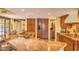 Open-concept kitchen with granite countertops, custom cabinetry, stainless appliances, and tile flooring at 12646 N 80Th Pl, Scottsdale, AZ 85260