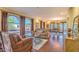 Sun-filled living room with large arched windows and hardwood floors, perfect for entertaining at 12646 N 80Th Pl, Scottsdale, AZ 85260