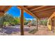 Spacious patio with brick flooring, wooden beams, and a view of the desert landscape at 12646 N 80Th Pl, Scottsdale, AZ 85260