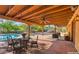 Expansive patio with wood ceiling overlooks the sparkling pool and beautifully landscaped backyard at 12646 N 80Th Pl, Scottsdale, AZ 85260