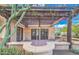 A covered patio featuring a wooden pergola, brick flooring, outdoor lighting, and stucco walls at 12646 N 80Th Pl, Scottsdale, AZ 85260