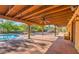 Large covered patio with brick flooring, ceiling fan, and views of pool and desert landscape at 12646 N 80Th Pl, Scottsdale, AZ 85260