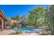 Backyard swimming pool featuring brick patio, desert landscaping, and built in BBQ at 12646 N 80Th Pl, Scottsdale, AZ 85260