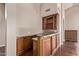 Wet bar area with granite countertop and custom cabinets with wine rack at 14207 W Kiowa Trl, Surprise, AZ 85374