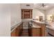 Wet bar area featuring granite countertop and custom cabinets with wine rack at 14207 W Kiowa Trl, Surprise, AZ 85374