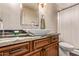 Bright bathroom with vessel sink, granite countertop and shower with white curtain at 14207 W Kiowa Trl, Surprise, AZ 85374