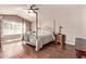 Bedroom with hardwood floors, a ceiling fan, and a four-poster bed at 14207 W Kiowa Trl, Surprise, AZ 85374