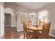 Inviting dining area with hardwood floors, a round wooden table, and ample natural light at 14207 W Kiowa Trl, Surprise, AZ 85374