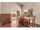 Cozy dining room with a rustic wooden table and matching chairs, adjacent to sliding doors at 14207 W Kiowa Trl, Surprise, AZ 85374