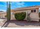 Manicured landscaping enhances the exterior of this single-story home, featuring desert plants and a tile roof at 14207 W Kiowa Trl, Surprise, AZ 85374