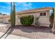 Manicured landscaping enhances the exterior of this single-story home, featuring desert plants and a tile roof at 14207 W Kiowa Trl, Surprise, AZ 85374