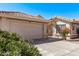 Single story home showcasing the front two car garage and tile roof and the private gated courtyard at 14207 W Kiowa Trl, Surprise, AZ 85374