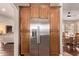 Kitchen with a stainless steel refrigerator with wood cabinets, and breakfast area at 14207 W Kiowa Trl, Surprise, AZ 85374